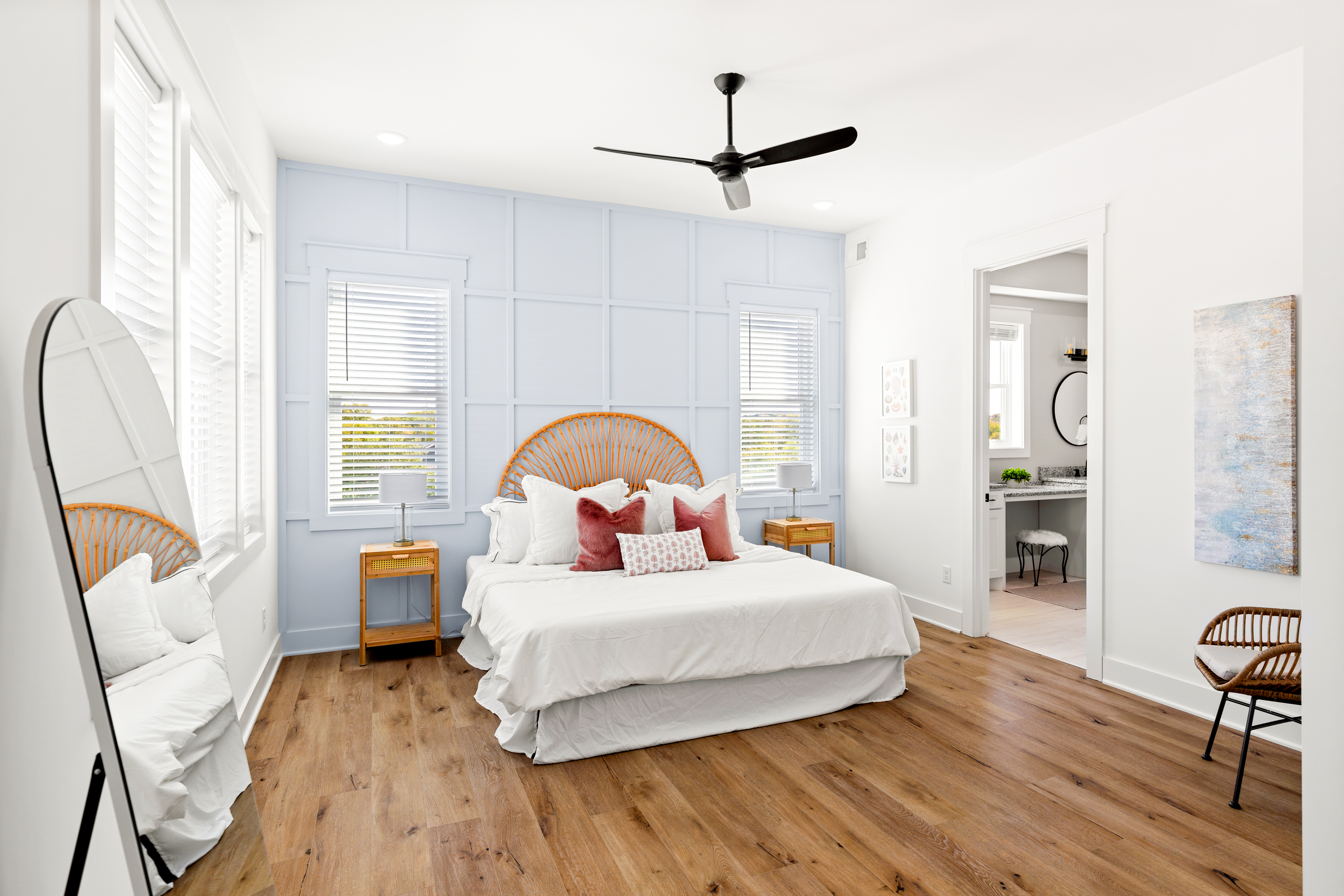 Spacious master bedroom with pastel blue accent wall
